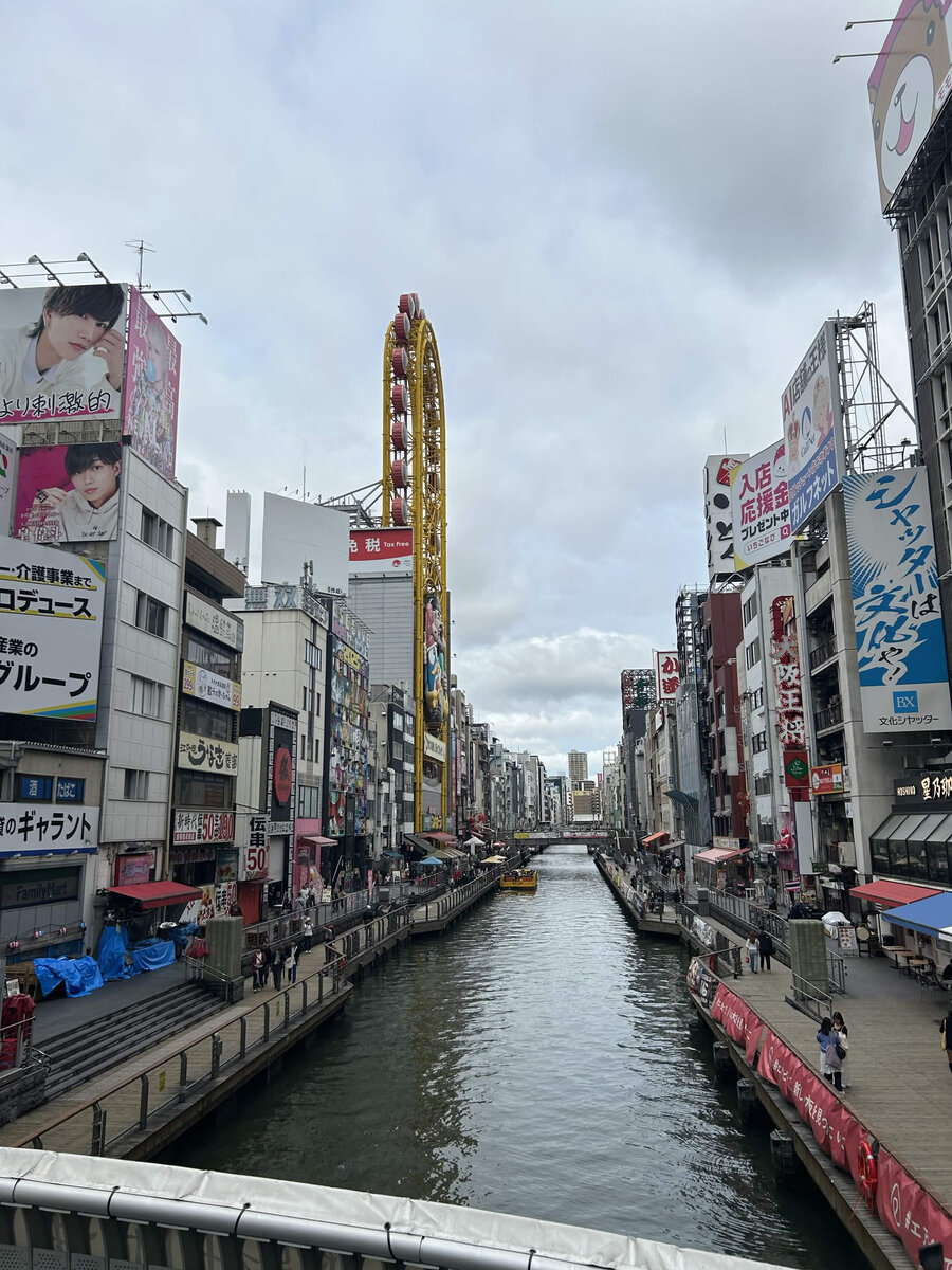 Dotonbori canal in Osaka, Japan, with the giant Ferris wheel and neon signage